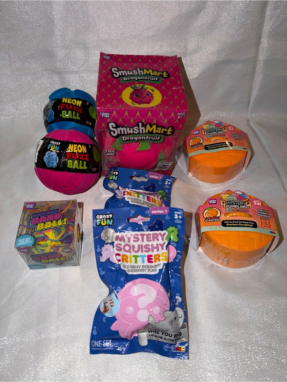 2 Scented Orange Dumplings, 1 Squishy DragonFruit, 2 Fuzz & Band Balls & 2 Bags